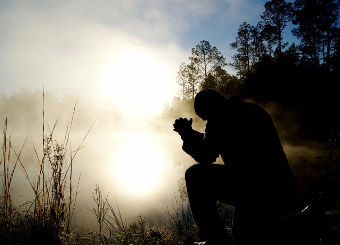 Man kneeling in prayer