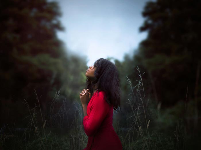 Woman praying outdoors